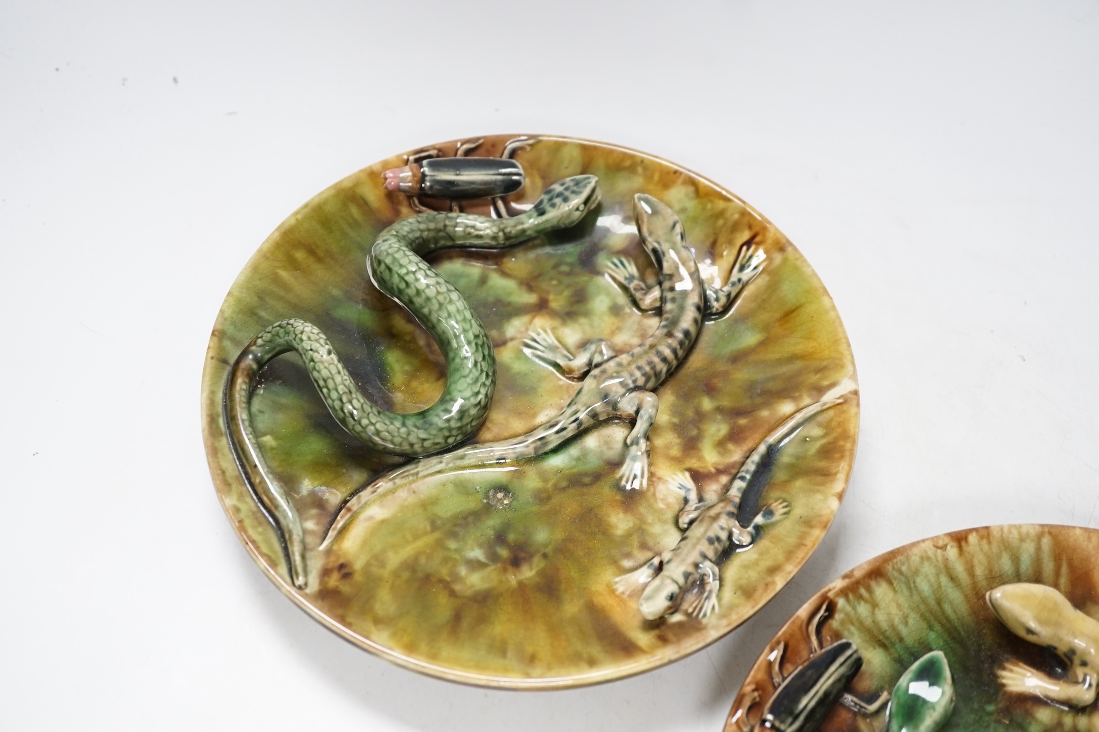 A pair of Palissy style Majolica glazed lizard plates, 23cm in diameter